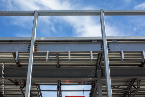 Quadro su tela Structural steel framework building with corrugated metal decking and concrete b