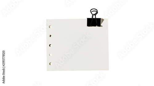 Isolated clean blank white paper sheet with five punched holes held by a black binder clip