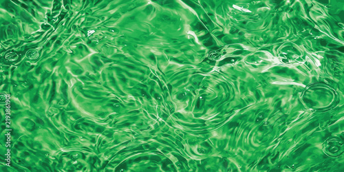 Foto Emerald green water surface with circular ripples and liquid texture abstract ba