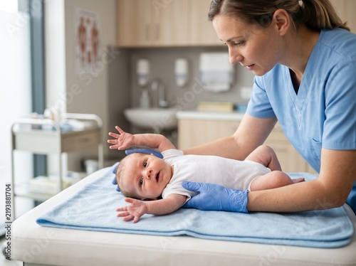 Newborn Moro Reflex Examination by Pediatrician During Neurological Screening