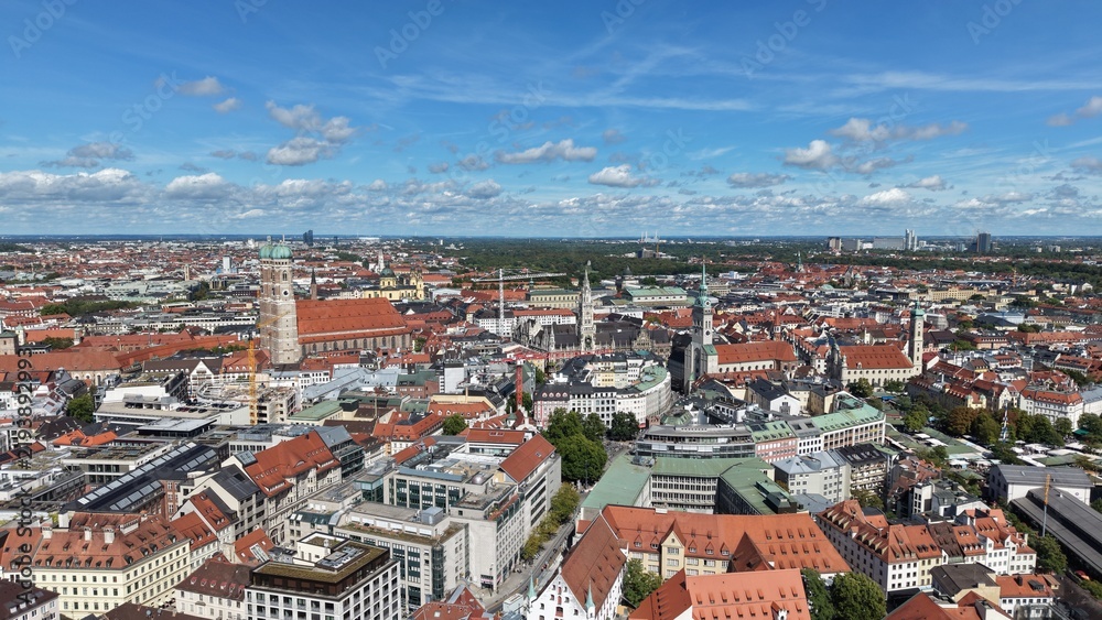 Obraz premium Aerial footage from St. Paul's Church in Munich, Germany. Cinematic drone shot revealing the neo-gothic architecture, green spires, and urban city skyline.