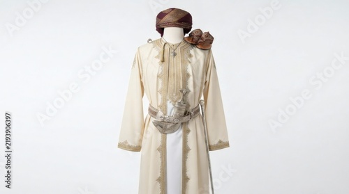 Traditional Omani male attire featuring embroidered bisht, national khanjar dagger, and turban displayed on mannequin