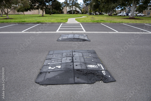 Obraz na plátne Worn and fragmented black rubber speed humps or deteriorating rubber speed bumps