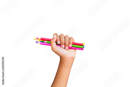 Child's hands holding colored pencils isolated on white background.