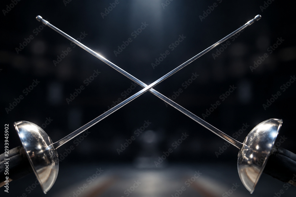 Fototapeta premium The crossed tips of two polished dueling foils forming an 'X' shape.
