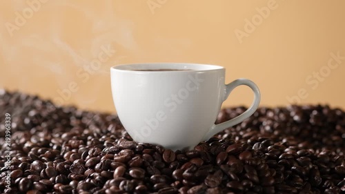 Hot coffee served in a white cup surrounded by roasted coffee beans, with open background space suitable for food, beverage and coffee advertising.