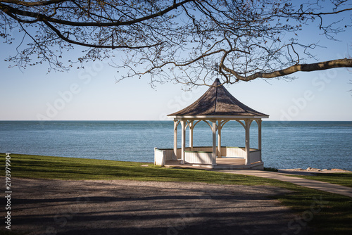 Photography Scenic lake park view with a traditional gazebo and calm blue water