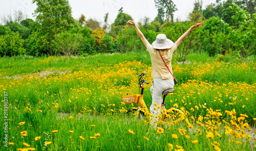 a young woman riding a bicycle in nature on a sunny day