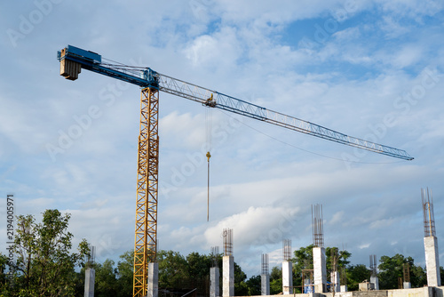 Принти на полотні Tall construction crane stands proudly at outdoor site under blue sky, represent