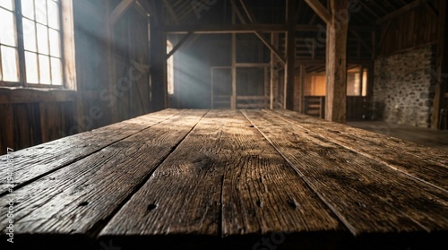 Rustic Wooden Table in Sunlit Barn with Natural Light Beams and Vintage Empty Interior for Product Presentation