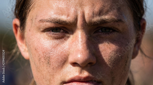 Close Up Portrait of Athletic Woman Face Covered in Sweat and Dirt After Intense Outdoor Workout