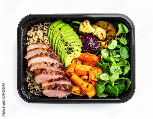 Healthy meal prep container filled with grilled duck breast, quinoa, roasted vegetables, avocado, and fresh greens, isolated background.