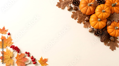 Pumpkins and autumn leaves arrangement with pinecones and berries. seasonal harvest concept for fall