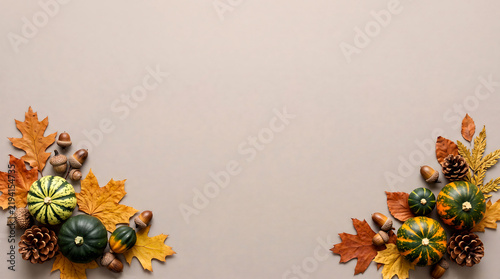 Squashes and foliage arrangement with acorns and autumn leaves on a gray background