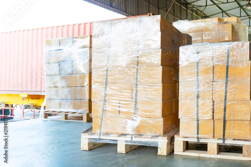 Bulk of Package Boxes Wrapped Plastic on Pallets. Truck Loading Dock Warehouse. Cardboard Boxes, Supply Chain, Goods Shipment. Distribution Warehouse Shipping Logistics	
