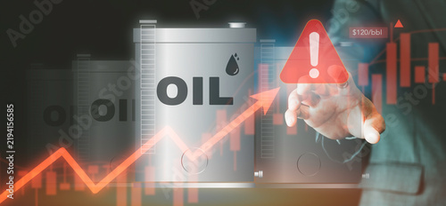 Businessman touching crude oil price surge warning concept. Energy crisis, oil barrel storage, stock market chart growth arrow, high inflation risk, and commodity trading strategy.