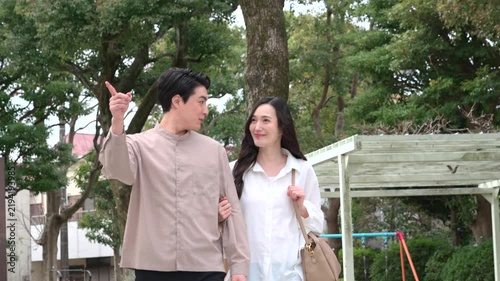 公園を歩くカップル30代日本人
