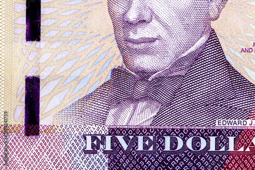Close-up of a 5 Liberian dollars banknote featuring a portrait of Presiden. Detailed macro shot of Liberia currency paper money bill.