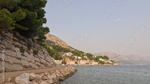 Rocky Croatian coastline with pine trees and seaside village