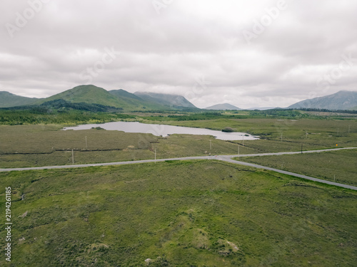 Obraz na plátně Aerial view of Lough Bofin in the Connemara region of County Galway, Ireland, surrounded by rugged mountains, green countryside and tranquil waters Galway, Ireland - 28 August 2026