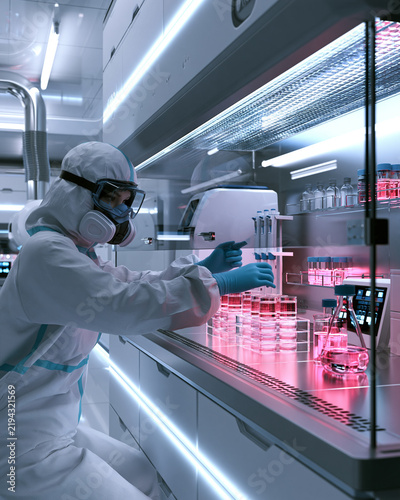 Scientist examining cell culture flasks in biotechnology laboratory