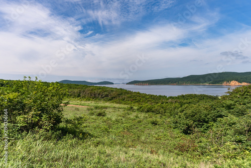Coastal landscape of Russky Island with green hills and sea near Vladivostok.