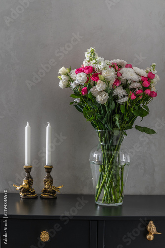 Elegant Floral Arrangement with White Chrysanthemums and Pink Roses in Glass Vase on Black Console Table.