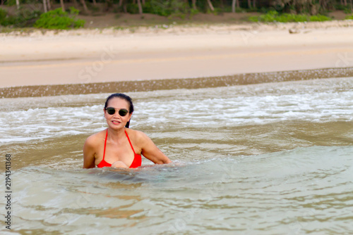 Woman with red bikini play water