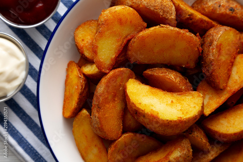Homemade Potato Wedges with Ketchup and Mayonnaise, top view.