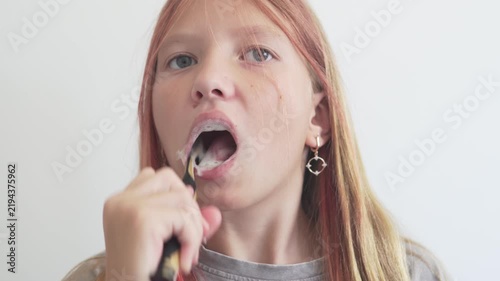 Close-up of a child brushing teeth at home, daily oral hygiene and dental care routine