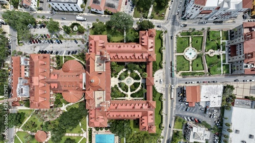 Aerial view of the historic Flagler College, formerly the Hotel Ponce de Leon, with its red-tiled roofs, central courtyard, and gardens in St. Augustine, Florida, United States.