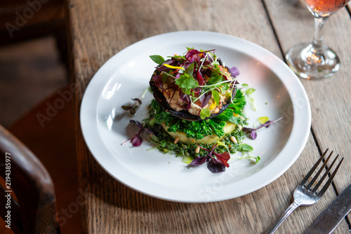 Quadro su tela Delightful Gourmet Dish With Vibrant Greens and Colorful Garnish on Wooden Table