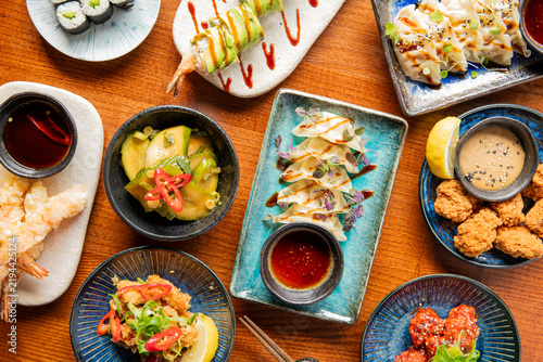 Delicious Array of Sushi and Asian Delicacies at a Vibrant Dining Table