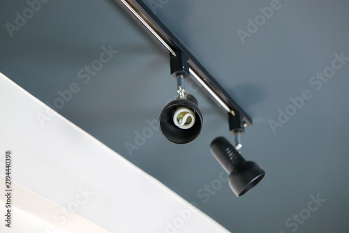 Cuadro en lienzo Ceiling spotlight fixture with two black adjustable lamps on metal track, modern