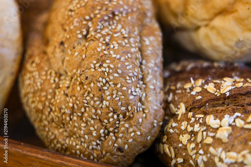 Obraz na płótnie Sesame bread loaf and oat topped bread loaf in bakery display
