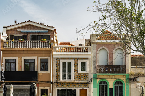 View of traditional Portuguese buildings with ornate tiled facades, wrought iron balconies, and architectural details in Setubal, Setubal, Portugal.