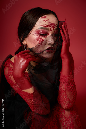 Spooky enchantress with a bloody face and dark elegance for Halloween