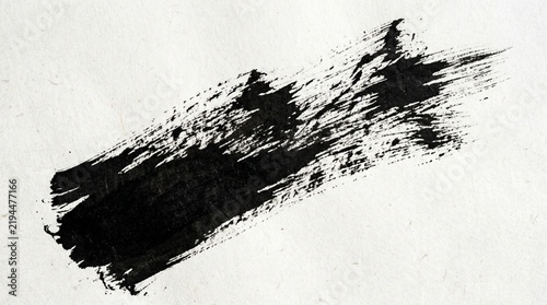 Black ink brush stroke on textured white paper, artistic abstract background