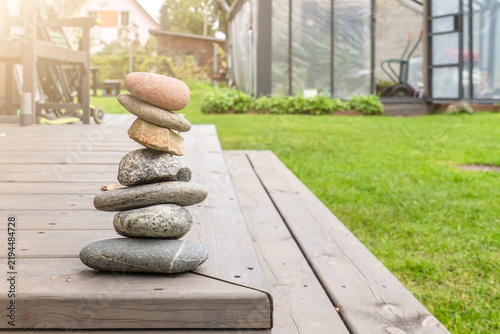 Photography Balanced Stone Cairn in a Sunlit Garden Setting