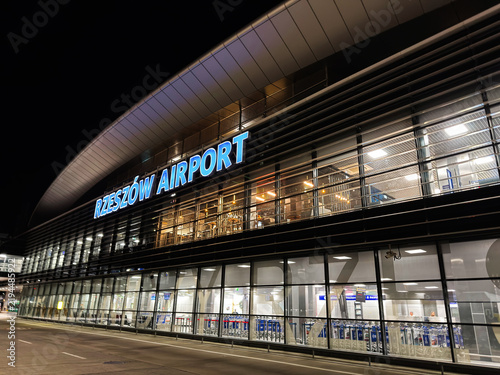 Rzeszow Airport terminal at night with illuminated signage and modern glass facade in Rzeszow, Poland welcoming travelers