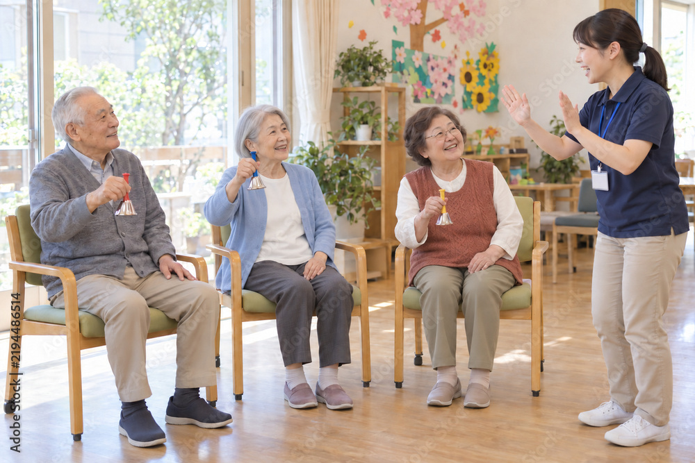 Fototapeta premium Japanese seniors enjoying handbell music at an adult day care center
