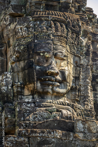 Photography Close up of a smiling giant stone face at Bayon temple in Angkor, Siem Reap, Cam