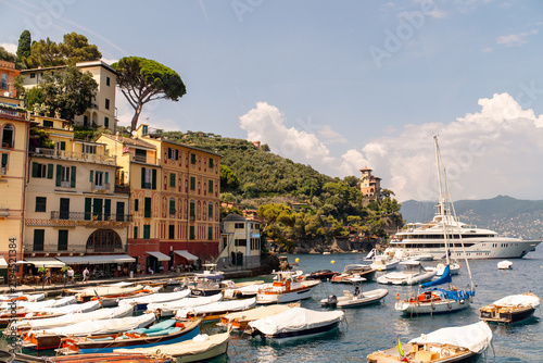 Konstfotografi Picturesque harbor of Portofino, Italy, filled with traditional boats and luxury yachts, surrounded by colorful historic buildings and lush Mediterranean hills