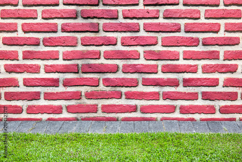 Background of old brick wall texture with grass ground.