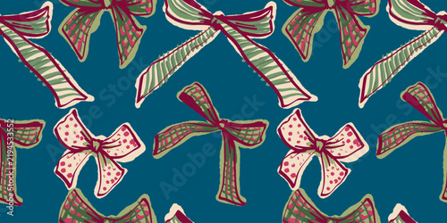 Seamless Christmas pattern featuring decorative bows and ribbons in cream, burgundy and green on a deep teal background, ideal for festive wrapping, textiles and paper packaging