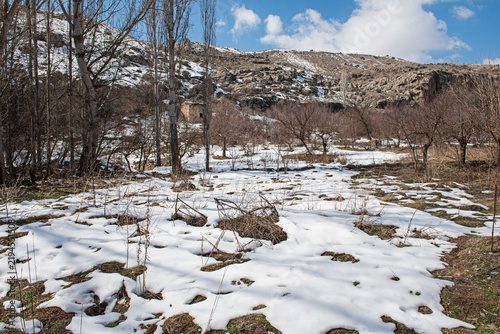 Panoramic landscape view across rural countryside valley during winter in Cappadocia Central Anatolia Turkey with snow on ground