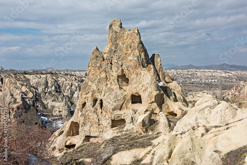 Panoramic landscape view across rural countryside Goreme valley during winter in Cappadocia Central Anatolia Turkey with geological fairy chimney rock formations and snow