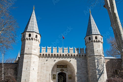 Closeup detail showing Entrance Gate of Salutations to Topkapi Palace in Istanbul Turkey against blue sky background