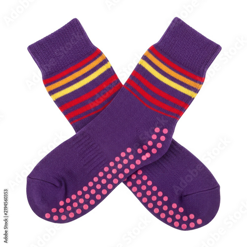 A pair of purple socks with colorful stripes and pink dots