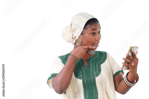 A pensive African woman talking in front of her phone screen